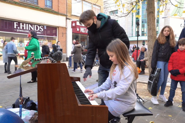 Young girl overcomes stage fright, plays piano, wows audience.